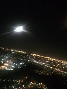 Moonrise over Houston. The bright full moon is caught under the wing, as we turn west toward Phoenix.